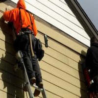 home-siding-repair-by-rain-carriers-midlothian-va-358x258 worker working on siding on a home by rain carriers